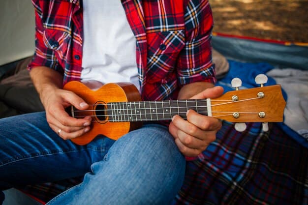 Man playing ukulele, close-up