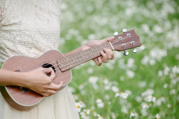 A girl in a field playing ukulele
